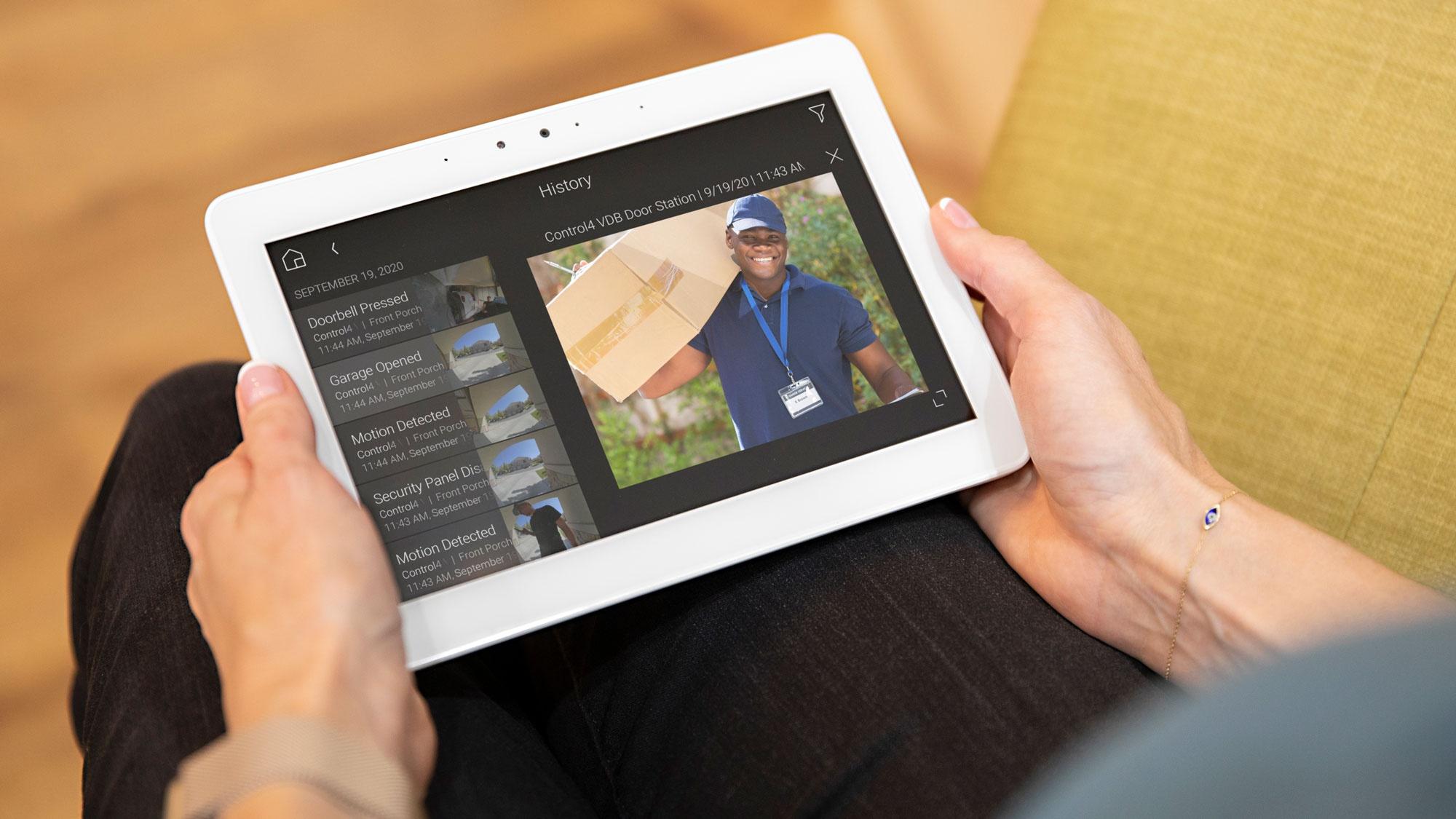 hands holding control4 touch panel